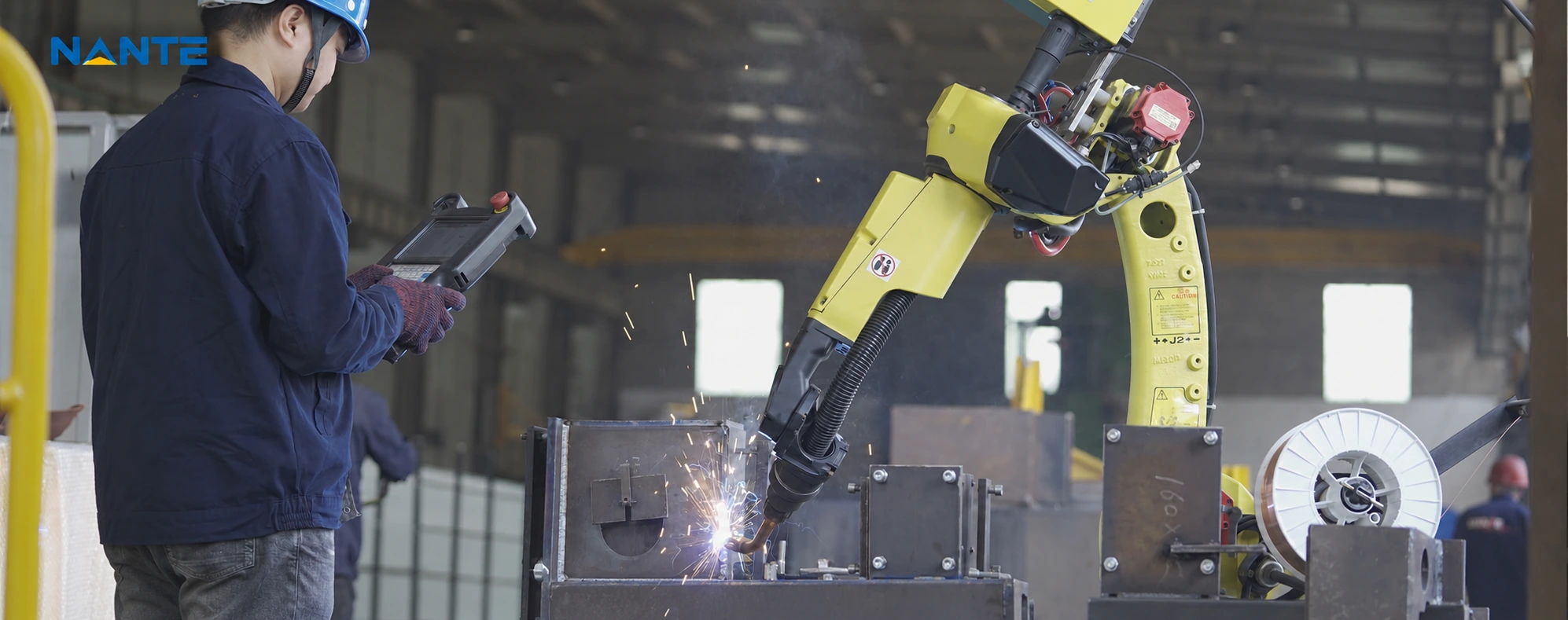 Robotic welding operation in a crane manufacturing workshop