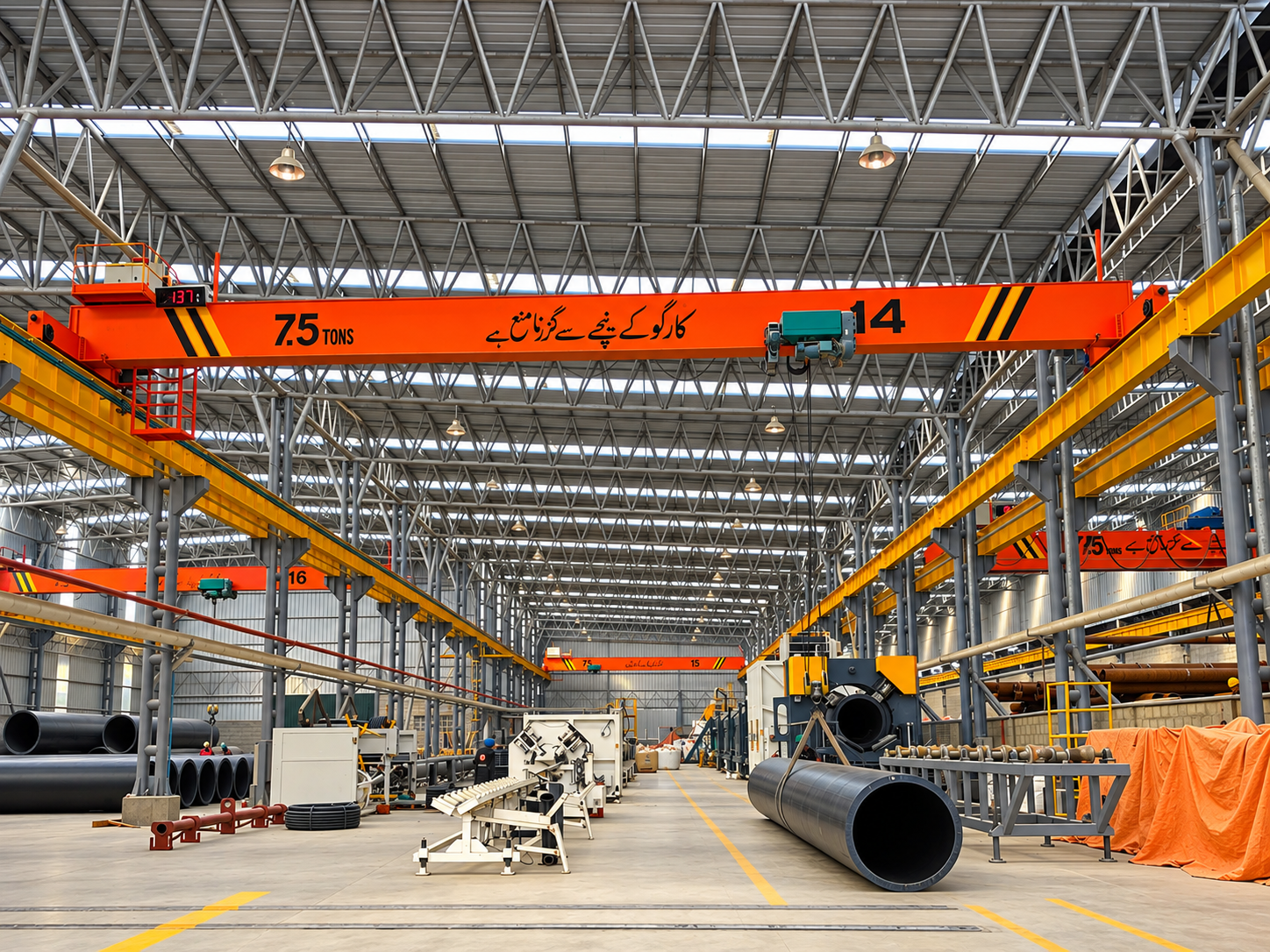 Overhead cranes operating inside a steel manufacturing workshop
